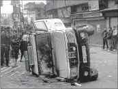  ??  ?? A police vehicle damaged during violence following the death a youth allegedly in police firing in Darjeeling, West Bengal on Saturday.