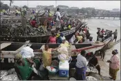  ?? SUNDAY ALAMBA — THE ASSOCIATED PRESS FILE ?? Fishermen sort their early morning catch from nets, at the fishing beach in the James Town area of Accra, Ghana, July 9, 2015.