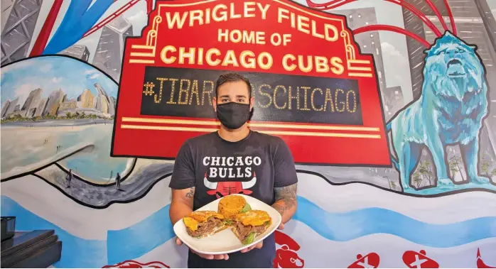  ?? BARRY BRECHEISEN/EATER CHICAGO ?? Jesus Arrieta presents his Puerto Rican-inspired jibarito, a sandwich that’s become a classic part of Chicago lore.