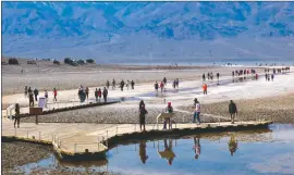  ?? Photo by Photo by Jon Klusmire ?? Visitors venture out to Lake Manley at Badwater Basin in Death Valley National Park.