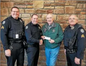  ?? SUBMITTED PHOTO ?? Central Berks Lions Club President Kenneth Snyder presented the club’s donation of $3,050 to Northern Berks Regional Police Chief Brian Horner, center, in January. Funds were used to purchase eight ballistic helmets for officers.