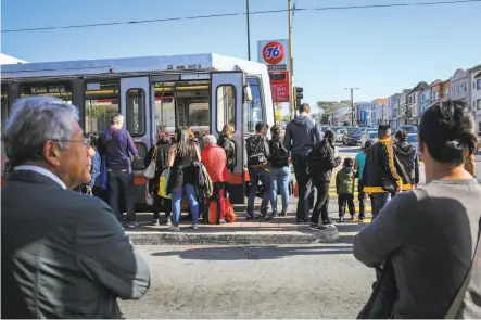  ?? Gabrielle Lurie / The Chronicle ?? Muni passengers wait for the next train after their N-Judah was turned around at Judah Street and 19th Avenue.