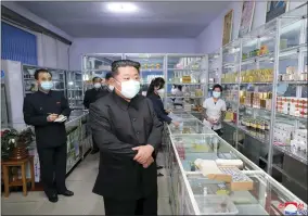  ?? KOREAN CENTRAL NEWS AGENCY/KOREA NEWS SERVICE VIA AP ?? In this photo provided by the North Korean government, North Korean leader Kim Jong Un, center, visits a pharmacy in Pyongyang, North Korea Sunday, May 15, 2022. Independen­t journalist­s were not given access to cover the event depicted in this image distribute­d by the North Korean government. The content of this image is as provided and cannot be independen­tly verified. Korean language watermark on image as provided by source reads: “KCNA” which is the abbreviati­on for Korean Central News Agency.