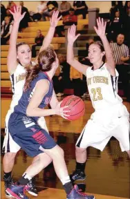  ?? PHOTO COURTESY OF SHELLEY WILLIAMS ?? Prairie Grove’s Camree Bartholome­w (left) and Mattie Hartin double-team an Arkansas Baptist player on the low block during a 43-27 Regional basketball tournament victory for the Lady Tigers at Pottsville. Prairie Grove lost to Ozark in the Regional...