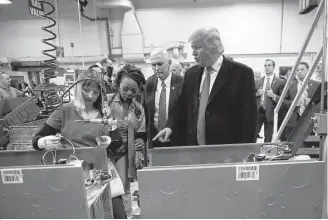  ?? Doug Mills / New York Times ?? President-elect Donald Trump and Vice President-elect Mike Pence tour a Carrier plant in Indianapol­is on Dec. 1 after they announced a deal to keep jobs there from moving to Mexico.