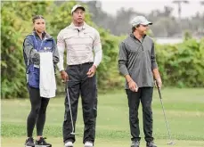  ?? Kevin Kolczynski/Associated Press ?? Tiger Woods, center, son Charlie, right, and daughter Sam look on during the first round of the PNC Championsh­ip on Saturday in Orlando, Fla.