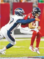  ?? AP PHOTO/RON SCHWANE ?? Denver Broncos linebacker Malik Reed sacks Atlanta Falcons quarterbac­k Kurt Benkert during last Thursday’s preseason game. Benkert was injured in the game.