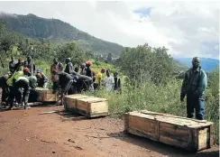  ?? Pictures: AFP/Zinyange Auntony ?? Men carry coffins along a makeshift path in Ngangu township in Chimaniman­i, Manicaland province, in eastern Zimbabwe.