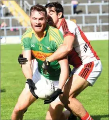  ?? South Kerry full forward Matthew O’Sullivan is caught in possession by Rathmore’s Aidan O’Mahony ??