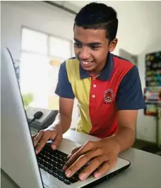  ??  ?? Keeping up: a student from sMK Jerlun using a computer to learn online.