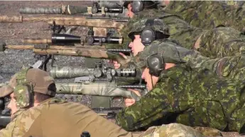  ?? KEVIN BISSETT/THE CANADIAN PRESS ?? Snipers calibrate their rifles before the 19th annual Canadian Internatio­nal Sniper Concentrat­ion’s opening day.
