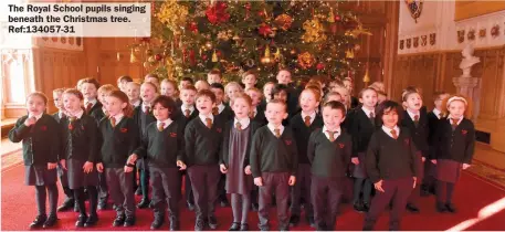  ?? ?? The Royal School pupils singing beneath the Christmas tree. Ref:134057-31