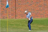  ?? AP PHOTO/DAVID J. PHILLIP ?? Xander Schauffele chips to the 16th green at Colonial Country Club during the third round of the Charles Schwab Challenge on Saturday in Fort Worth, Texas. Schauffele shot a 66 and had a one-shot lead entering the final round.