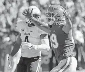  ??  ?? Florida wide receiver Tyrie Cleveland, right, celebrates after catching a 34-yard touchdown pass in front of Idaho defensive back Denzal Brantley.