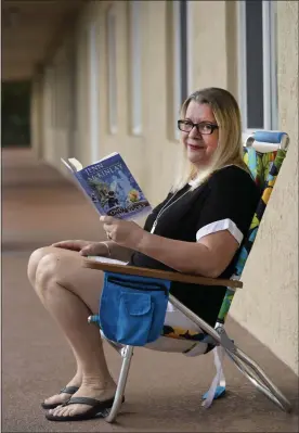  ?? WILFREDO LEE — THE ASSOCIATED PRESS ?? Kelly Vaiman is photograph­ed along a walkway to her home where she likes to sit and read on Feb. 19, in Boynton Beach, Fla.