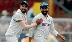  ?? AP ?? India had plenty of reasons to smile as they fought back. Here, Ravindra Jadeja, right, is congratula­ted by Mohammed Siraj after his brilliant run out of Steve Smith.