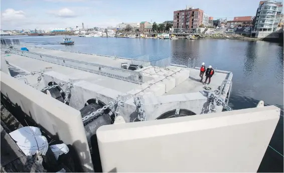  ??  ?? A 380-foot-long, 50-foot-wide floating pontoon gets a final look at Point Hope Maritime shipyard. It’s scheduled to be towed out of the Upper Harbour at 8 this morning on a trip to the Sunshine Coast. The pontoon’s permanent home will be at B.C. Ferries’ Langdale terminal.