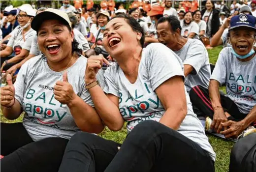  ?? SONNY TUMBELAKA/AFP VIA GETTY IMAGES ?? Did someone at this event in Bali, Indonesia, tell a good joke? Or was it a jayus?