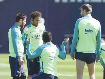  ?? — Reuters ?? Barcelona’s Lionel Messi, Neymar, Luis Suarez and Gerard Pique speak during a training session.