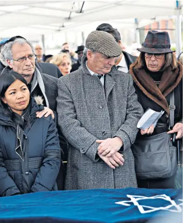  ??  ?? Mireille Knoll’s family pay their respects at the 85-year-old’s funeral, joined by the French President Emmanuel Macron, top left