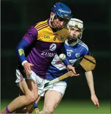  ??  ?? Wexford’s Kevin Foley giving Stephen Bergin of Laois the slip.