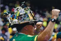  ?? JOSE CARLOS FAJARDO — STAFF ARCHIVES ?? A’sfanMark Garcia, of Danville, wears his A’s firefighte­r helmet while cheering in the fourth inning during the Athletics’ home opener at the Coliseum in Oakland on March 28, 2019.