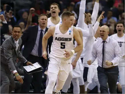  ?? GREGORY SHAMUS – GETTY IMAGES ?? Sam Merrill, front, and the Utah State Aggies have been the stars of the virtual NCAA Tournament, winning their first two games.
