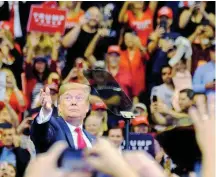  ??  ?? US President Donald Trump tosses a ‘Make America Great Again’ (MAGA) hat at a campaign rally in the BB&T Center in Sunrise, Florida, on Tuesday.