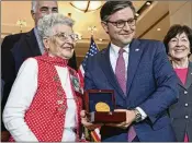  ?? ?? House Speaker Mike Johnson presents a medal to Mae Krier, 98, a former “Rosie” who was one of the driving forces behind the legislatio­n that honored the women.