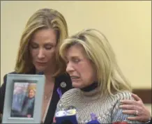  ??  ?? Beth Perz is comforted by Chester County Commission­er Michele Kichlline, as Perz talked about her son Brad Perz, 24, who died in December from opioid addiction.