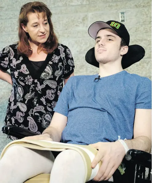  ?? JEFF MCINTOSH / THE CANADIAN PRESS ?? Humboldt Broncos hockey player Ryan Straschnit­zki, who was paralyzed following a bus crash that killed 16 people, discusses his challenges and ambitions as his mother Michelle looks on in Calgary on Wednesday.