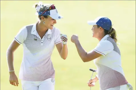  ?? Harry How/Getty Images ?? Team USA’s Cristie Kerr, right, celebrates a birdie putt with Lexi Thompson in the afternoon four-ball matches against Team Europe in the Solheim Cup. Kerr and Thompson went on to win the match in a big day for Team USA and for Kerr individual­ly at Des...