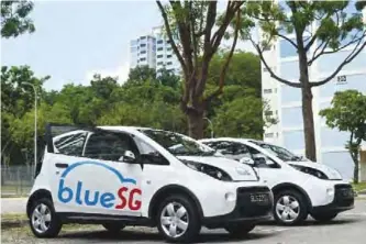  ??  ?? SINGAPORE: This photograph taken on Tuesday shows the electric Bluecars ahead of the launch of a BlueSG office, a subsidiary of France’s Bollore Group, in Singapore. The electric car-sharing service will launch in Singapore in December, in what the...