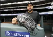  ?? THE ASSOCIATED PRESS FILE PHOTO ?? Colorado Rockies rookie starting pitcher Antonio Senzatela shows the inscriptio­n on his baseball glove to his mother, Nidya, in Denver.