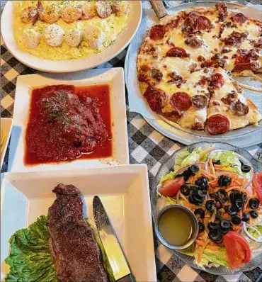  ?? Photos by Susie Davidson Powell / For the Times Union ?? Papa Brillo's fare includes, clockwise from top, pasta alfredo with shrimp and scallops, pizza, salad, steak and meatballs.