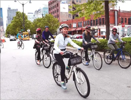  ?? Photo by Steve MacNaull ?? Bobby’s Chicago Bike Hike group cycles through Fulton Market District, the former meat-packing district turned restaurant and tech hotspot.