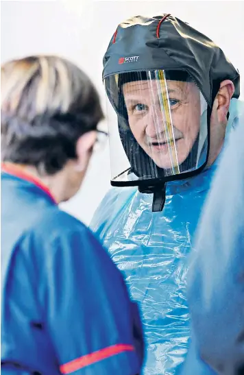  ??  ?? A staff member at Royal Sussex County Hospital in Brighton wears protective clothing to treat suspected coronaviru­s sufferers