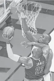  ?? Nathan Denette / Canadian Press ?? The Raptors’ Bismack Biyombo, right, blocks the shot of Cavaliers star LeBron James in the second half of Saturday’s game. Biyombo had four blocks, 26 rebounds and seven points in Toronto’s victory.