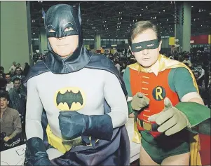  ?? AP PHOTO ?? In this 1989 photo, actors Adam West, left, and Burt Ward, dressed as their characters Batman and Robin, pose for a photo at the World of Wheels custom car show in Chicago. On Saturday, West’s family said the actor, who portrayed Batman in a 1960s TV...