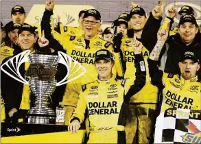  ?? Terry Renna / Associated Press ?? Matt Kenseth, center, stands next to the trophy in Victory Lane after winning the NASCAR Sprint Unlimiteda­t Daytona Internatio­nal Speedway in 2015.