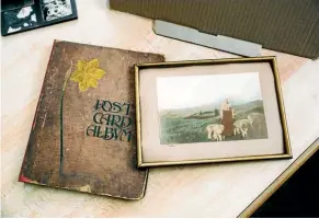  ?? PHOTO: DAVID JAMES/STUFF ?? A postcard album and an early coloured photograph found in the collection.