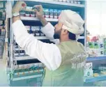  ?? ?? A tax official inspecting excisable goods at an outlet in Dhofar (Picture credit: Oman Tax Authority)