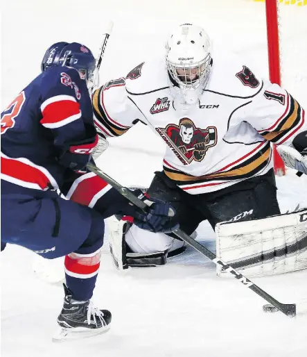  ?? LEAH HENNEL ?? Regina Pats forward Sam Steel, left, scores one of his two goals on Calgary Hitmen goalie Trevor Martin Wednesday at Scotiabank Saddledome during the Pats’ 4-0 victory. The standout forward had a hand in all four Regina goals.