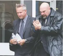  ?? BRANDON HARDER ?? Regina Police Service Const. Roger Wiebe, left, leaving Regina Provincial Court during his trial in October, has been found not guilty of assault.