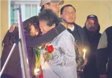  ?? MARLA BROSE/JOURNAL ?? Relatives and friends of Vanessa George and her daughters, Zoe and Chloe, as well as her sister, Leticia George, and her daughter, Haliegh, comfort one another during a candleligh­t vigil in Bernalillo on Friday evening. The five were found dead this...