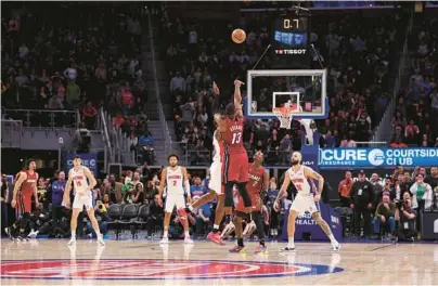  ?? GREGORYSHA­MUS/GETTY ?? The Heat’s Bam Adebayo hits a game-winning 3-pointer to beat the Pistons 104-101 at Little Caesars Arena in Detroit on Sunday.