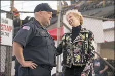  ?? Steph Chambers/Post-Gazette ?? Supervisor of Citizens Hose EMS Jim Erb has a conversati­on with Laura Ellsworth at Lernervill­e Speedway in Sarver.