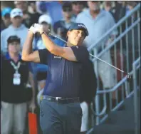  ?? The Associated Press ?? EYEING HIS SHOT: Phil Mickelson watches his shot on the 10th tee Thursday during the Shriners Hospitals for Children Open at TPC Summerlin in Las Vegas.