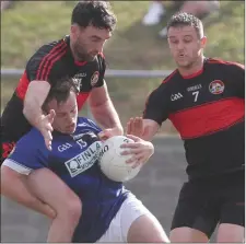  ??  ?? St. Mary’s Conor Gillespie can’t get through Dreadnots duo James Califf and David O’Brien.