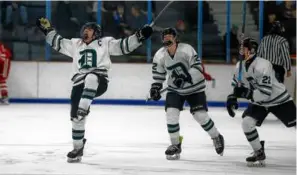  ?? MATTHEW J. LEE/GLOBE STAFF ?? Duxbury senior captain Brady Walsh (left) celebrates a secondperi­od power-play tally, his fifth goal in three playoff games.